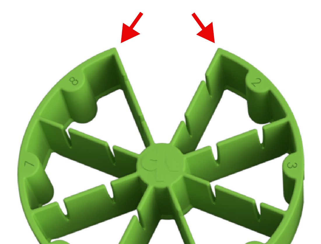Image is zoomed in, with red arrows highlighting the spacing on the outside wall of the partition at position one. This spacing aligns with the vertical alignment feature on the strainer itself for precise placement.
